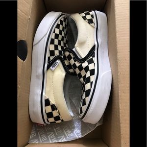 Vans kids black/off white checkerboard slip ons.